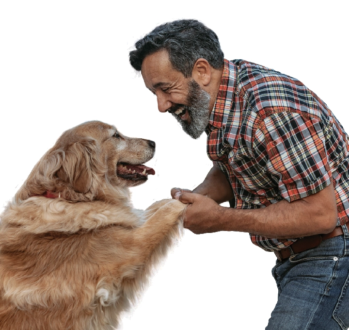 man smiling while holding his dog's paws